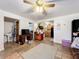 Living room with open kitchen view, tiled floors and a ceiling fan at 151 Pine St, Babson Park, FL 33827