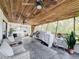 Spacious screened porch with ceiling fan, comfortable seating, and tropical mural at 151 Pine St, Babson Park, FL 33827