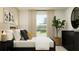 Cozy bedroom with a full bed, dresser, and large window at 1299 Inkberry Cir, Deland, FL 32720