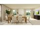 Bright dining room with wooden table, six chairs, and large windows at 1299 Inkberry Cir, Deland, FL 32720