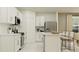 Modern kitchen with island, white cabinets, and stainless steel appliances at 1299 Inkberry Cir, Deland, FL 32720