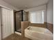 Bathroom with shower, garden tub, and tiled floors at 2504 Preserve Ct, Mulberry, FL 33860