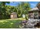 Large backyard with shed, fire pit, and screened porch at 2739 Everleth Dr, Lakeland, FL 33810
