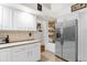White cabinets, stainless steel refrigerator, and granite countertops at 2739 Everleth Dr, Lakeland, FL 33810