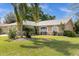 Tan house with a two-car garage and lush landscaping at 2739 Everleth Dr, Lakeland, FL 33810