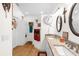 Double vanity bathroom with granite countertops and large mirrors at 2739 Everleth Dr, Lakeland, FL 33810