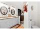 Bathroom with double sinks, granite countertops and a separate toilet area at 2739 Everleth Dr, Lakeland, FL 33810