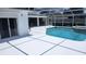 White-tiled pool and spa with screened enclosure at 2514 Sage Dr, Kissimmee, FL 34758