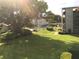 Community pool and surrounding landscape, easily accessible from condo at 333 Lake Howard Nw Dr # 204C, Winter Haven, FL 33880