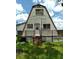 A-frame house with a wooden deck and stairs at 11390 E Irlo Bronson Memorial Hwy, St Cloud, FL 34773