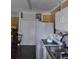 Kitchen features white cabinets, stove, refrigerator and double sink at 11390 E Irlo Bronson Memorial Hwy, St Cloud, FL 34773
