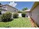 Neat backyard with flowering bushes, a white fence, and a grassy area at 389 Old Alemany Pl, Oviedo, FL 32765