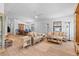 Bright living room featuring light wood floors and wicker furniture at 1967 Long Boat Dr, Lakeland, FL 33810