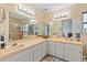 Bathroom with double vanity, large mirror, and a shower at 1967 Long Boat Dr, Lakeland, FL 33810