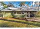 Charming cottage with metal roof, screened porch, and brick steps at 10801 Sw 185Th Ter, Dunnellon, FL 34432