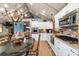 Open concept kitchen and dining area with white cabinets and stainless steel appliances at 10801 Sw 185Th Ter, Dunnellon, FL 34432