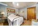 Simple bedroom with an antique metal bed frame, wooden nightstand, and wall art at 10801 Sw 185Th Ter, Dunnellon, FL 34432