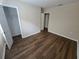 Spacious bedroom featuring wood-look floors and a large closet at 1911 High St, Leesburg, FL 34748