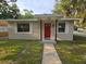 House exterior with red door and landscaping at 1911 High St, Leesburg, FL 34748