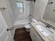 Updated bathroom with granite vanity and marble-look tile at 1911 High St, Leesburg, FL 34748