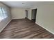 Large living room with wood-look floors at 1011 Gunston St, Leesburg, FL 34748