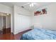 Bright bedroom with hardwood floors, double door closet and large wall art at 612 Terrace Ridge Cir # 612, Davenport, FL 33896