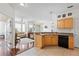 Open kitchen with light wood cabinets, stainless steel appliances, and breakfast bar at 612 Terrace Ridge Cir # 612, Davenport, FL 33896