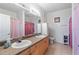 Bathroom with double vanity and large mirror at 612 Terrace Ridge Cir # 612, Davenport, FL 33896