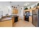 Bright kitchen with wood cabinets, stainless steel appliances, and tile floor at 612 Terrace Ridge Cir # 612, Davenport, FL 33896
