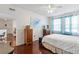 Bedroom with wood floors, dresser, and window at 612 Terrace Ridge Cir # 612, Davenport, FL 33896