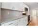 Modern kitchen with white cabinets and granite countertops at 2834 Eaton Ave, Eaton Park, FL 33840