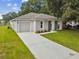 House exterior featuring a gray exterior, driveway, and landscaping at 2834 Eaton Ave, Eaton Park, FL 33840