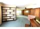 Spacious living room featuring built-in shelving and wood paneling at 250 W New York Ave, Orange City, FL 32763