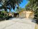 Home with attached two-car garage and spacious driveway at 250 W New York Ave, Orange City, FL 32763