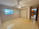 Bright bedroom with window, closet, and view of kitchen at 250 W New York Ave, Orange City, FL 32763
