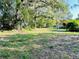 Vacant lot ready for your dream home, featuring lush landscaping and mature trees at 250 W New York Ave, Orange City, FL 32763
