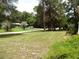 Large front yard with mature trees and a peaceful setting at 217 Catalonia Ave, De Leon Springs, FL 32130