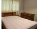 Simple bedroom with a double bed and wood dresser at 217 Catalonia Ave, De Leon Springs, FL 32130