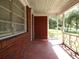 Charming front porch with brick columns and a view of the yard at 217 Catalonia Ave, De Leon Springs, FL 32130