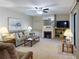 Living room with fireplace, comfortable seating, and a large TV at 4150 S Atlantic Ave # 107C, New Smyrna Beach, FL 32169