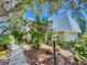 Two-story condo building with lush landscaping and walkway at 4150 S Atlantic Ave # 107C, New Smyrna Beach, FL 32169
