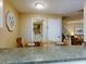 Kitchen and dining area with adjacent laundry and staircase at 4150 S Atlantic Ave # 107C, New Smyrna Beach, FL 32169