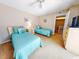 Bedroom with two twin beds and coastal decor at 4150 S Atlantic Ave # 107C, New Smyrna Beach, FL 32169