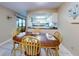 Bright dining area with table and chairs, open to kitchen at 4150 S Atlantic Ave # 107C, New Smyrna Beach, FL 32169
