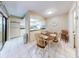 Kitchen and dining area with table and chairs, and access to patio at 4150 S Atlantic Ave # 107C, New Smyrna Beach, FL 32169