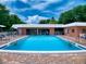 Community pool and surrounding deck area at 4150 S Atlantic Ave # 107C, New Smyrna Beach, FL 32169