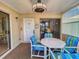 Sunroom with table and chairs, and access to the front door at 4150 S Atlantic Ave # 107C, New Smyrna Beach, FL 32169