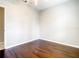 Simple bedroom with dark hardwood floors and neutral walls at 319 Ravenshill Way, Deland, FL 32724