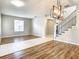 Spacious dining area features hardwood floors and elegant staircase at 319 Ravenshill Way, Deland, FL 32724