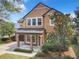 Two story house with brown exterior and front porch at 319 Ravenshill Way, Deland, FL 32724